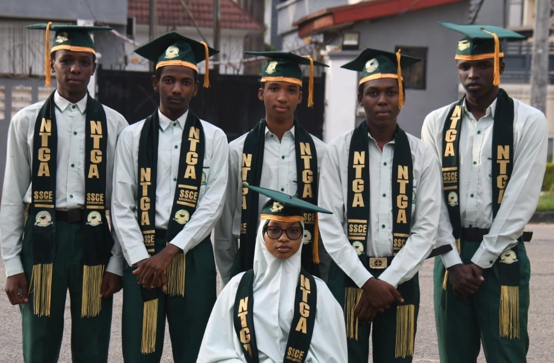 Group portrait of NTGA SSCE graduates in green caps and gold tassels