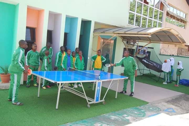 Students playing table tennis in the school yard